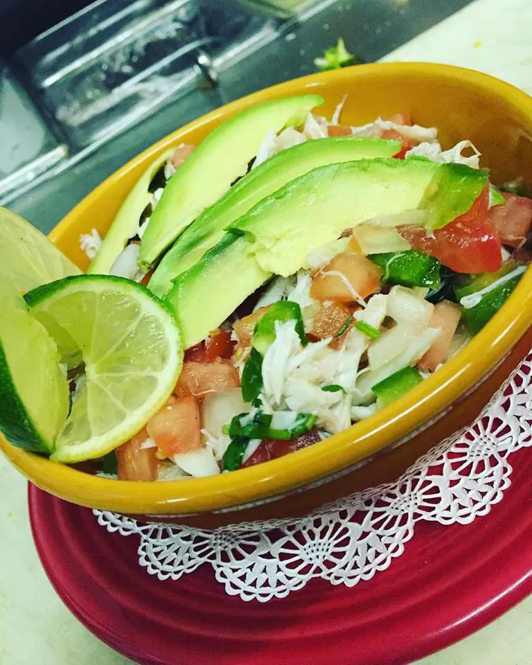 Crab salsa with avocado slices and lime